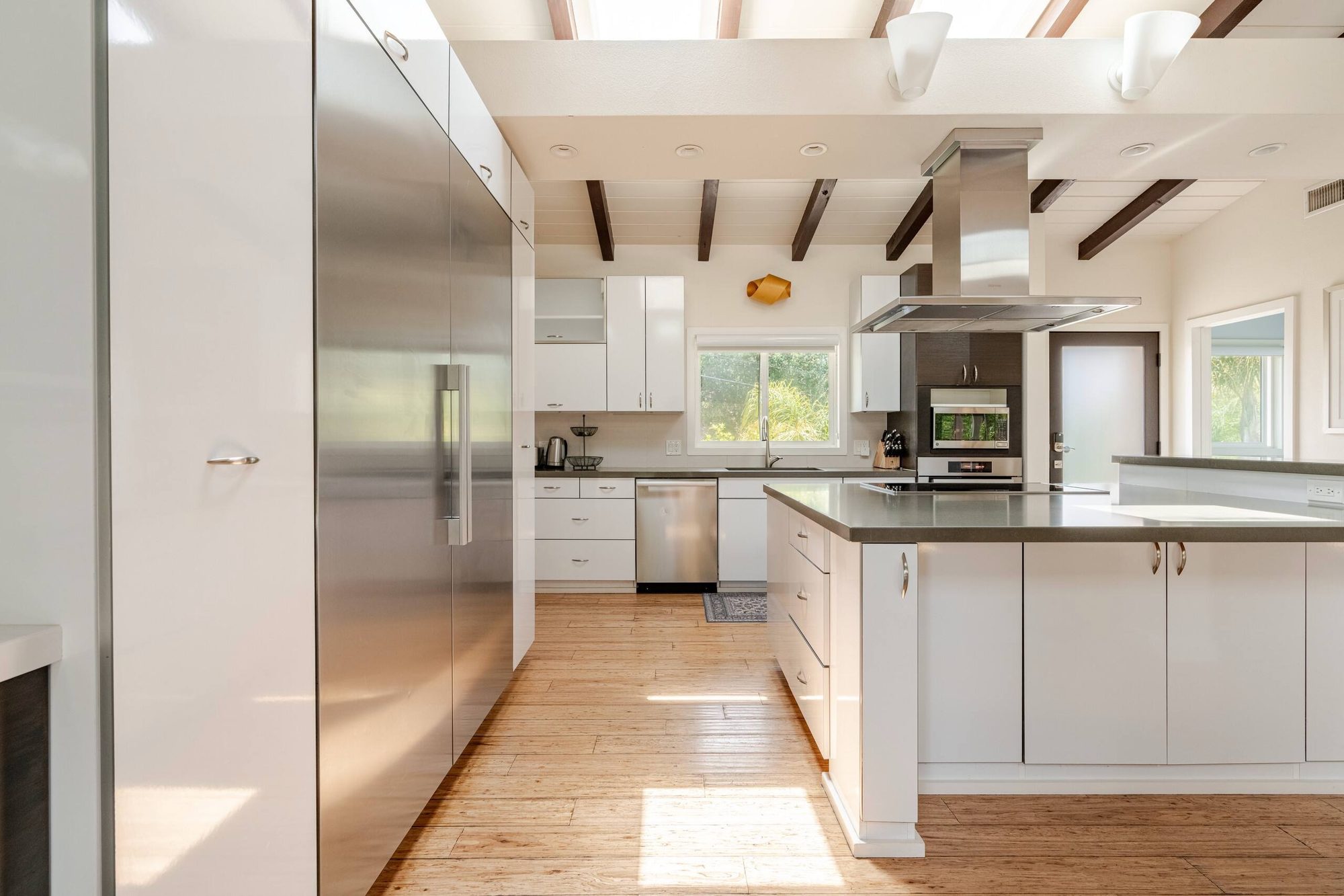 Kitchen galley view down to the full-height built-in refrigerator wall